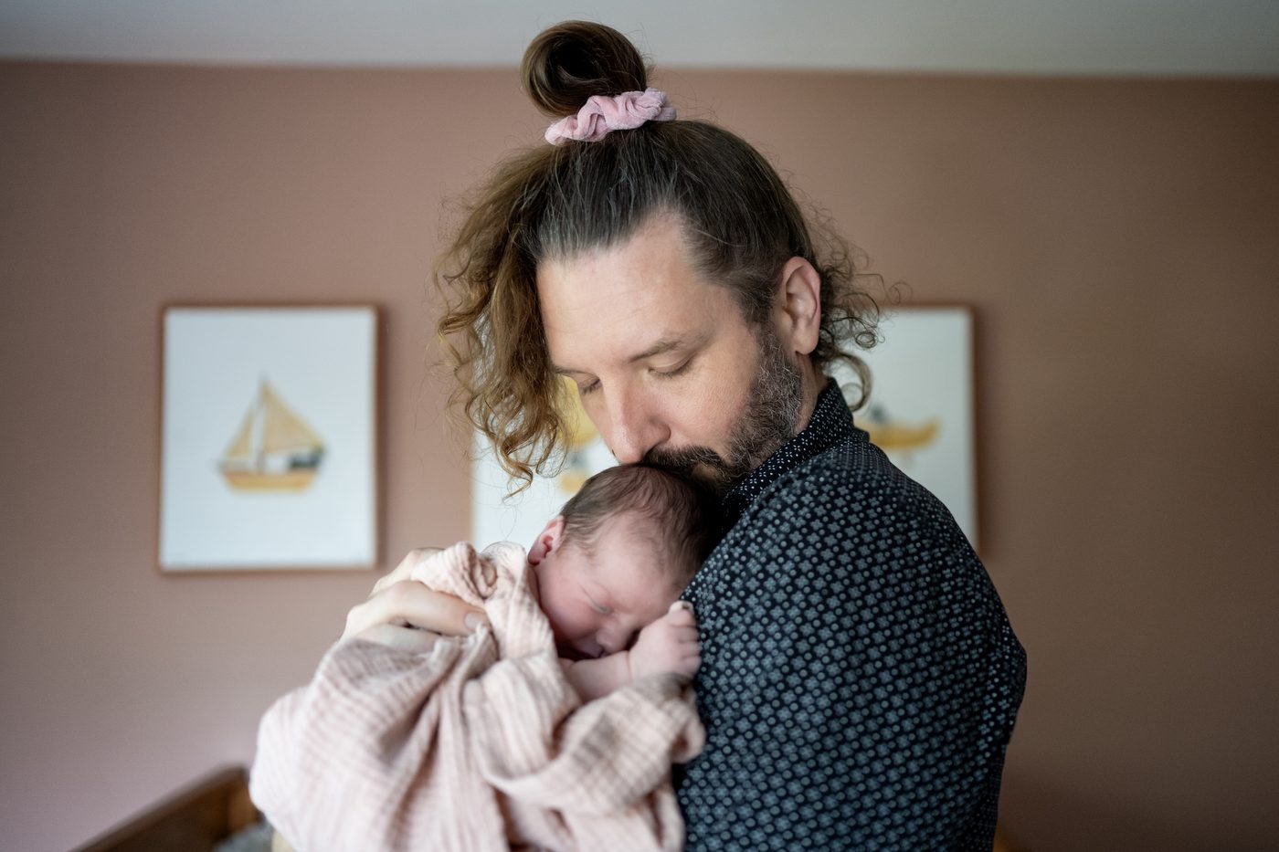 A father holding his sleeping newborn against his chest